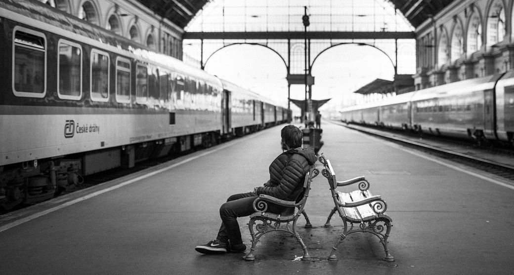 man waiting in a train station