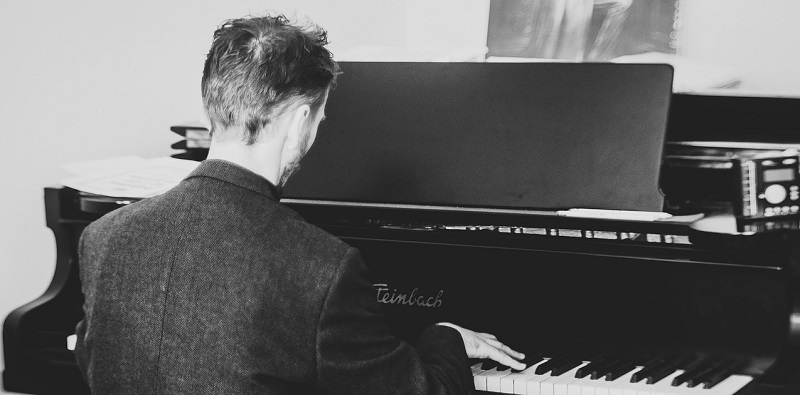 man practicing piano